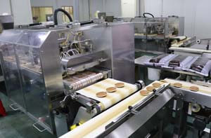 Depositing filling, sealing, and packaging are automated.